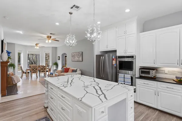 a living room with furniture and kitchen view