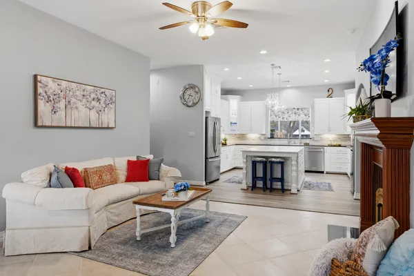 a living room with furniture a flat screen tv and a fireplace
