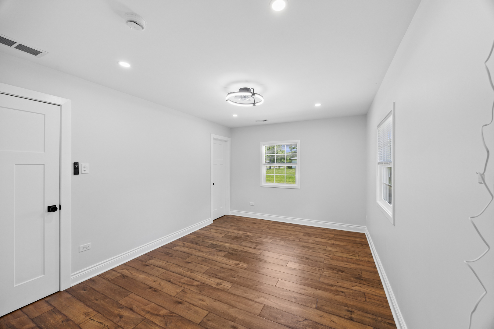 570 Andover Street Chicago Heights, IL 60411 - Photo 17 of 22 wooden floor in an empty room with a window
