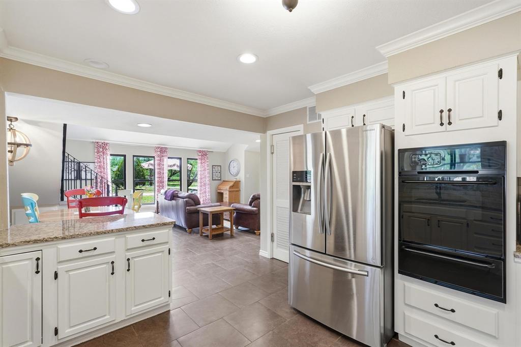 432 Clark Road Abilene, TX 79602 - Photo 9 of 40 a kitchen with white cabinets and stainless steel appliances