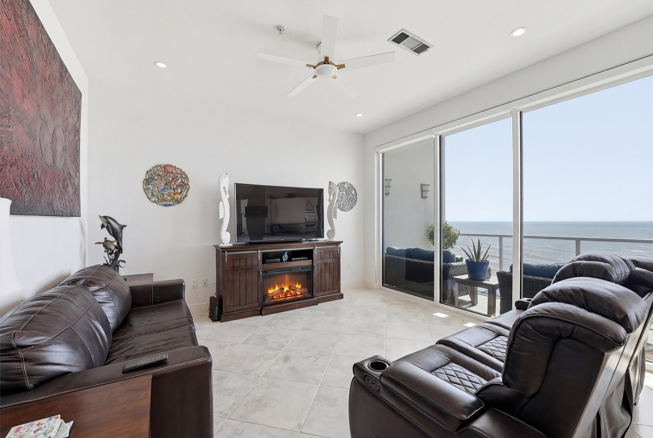 10327 Termini-San Luis Pass Road, Unit 616 Galveston, TX 77554 - Photo 12 of 38 a living room with furniture and a flat screen tv