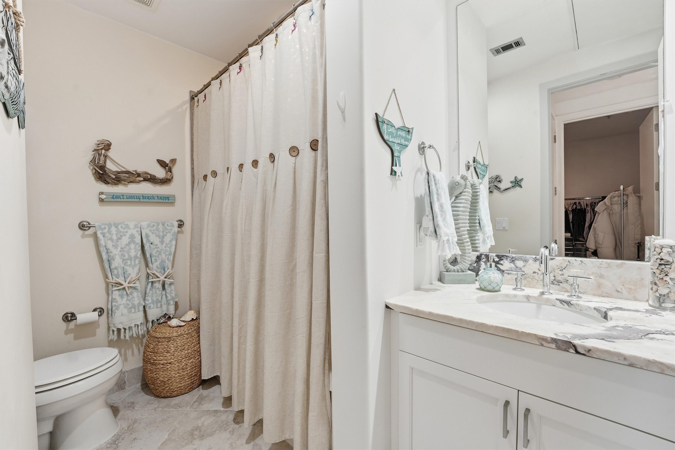 10327 Termini-San Luis Pass Road, Unit 616 Galveston, TX 77554 - Photo 15 of 38 a bathroom with a granite countertop sink and a mirror