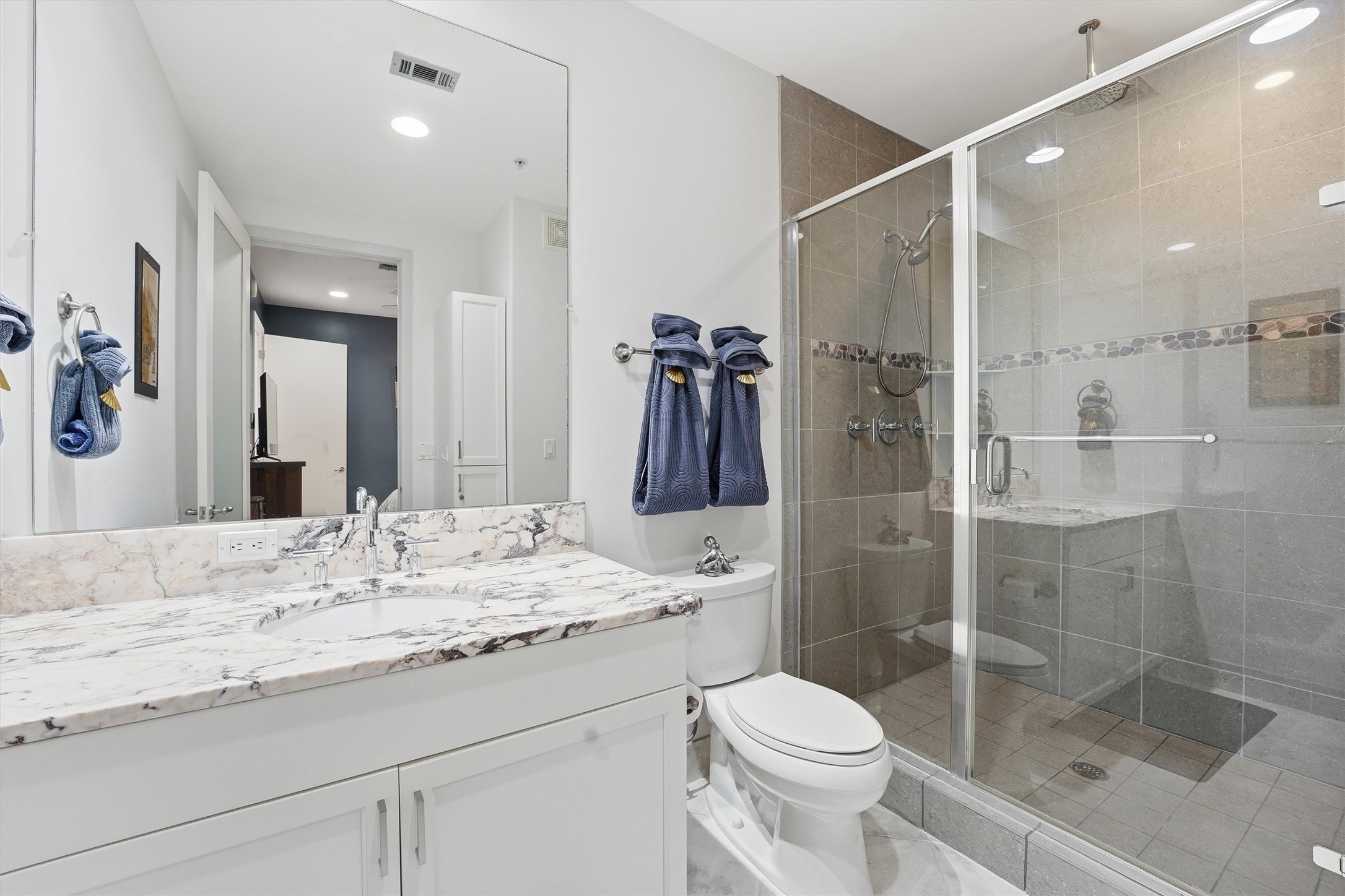 10327 Termini-San Luis Pass Road, Unit 616 Galveston, TX 77554 - Photo 16 of 38 a bathroom with a granite countertop sink toilet and shower