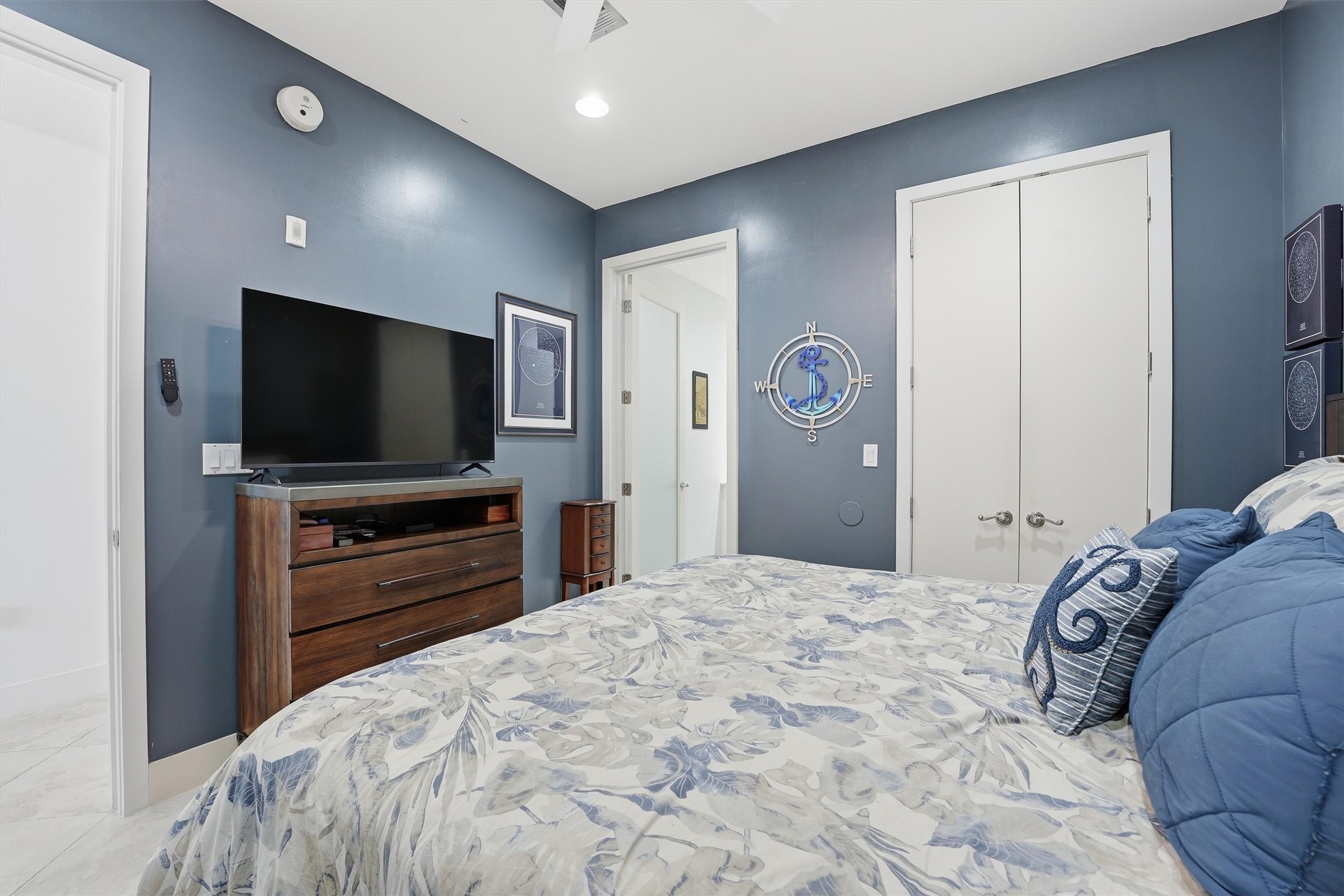 10327 Termini-San Luis Pass Road, Unit 616 Galveston, TX 77554 - Photo 18 of 38 a bedroom with a bed and a flat screen tv in it