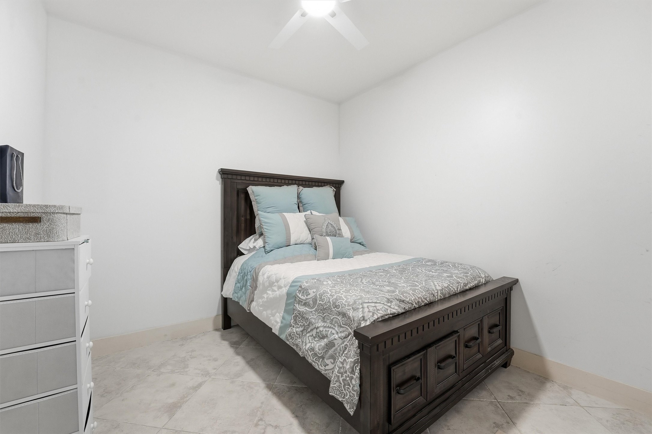 10327 Termini-San Luis Pass Road, Unit 616 Galveston, TX 77554 - Photo 19 of 38 a bed sitting in a bedroom next to a bathroom with a sink