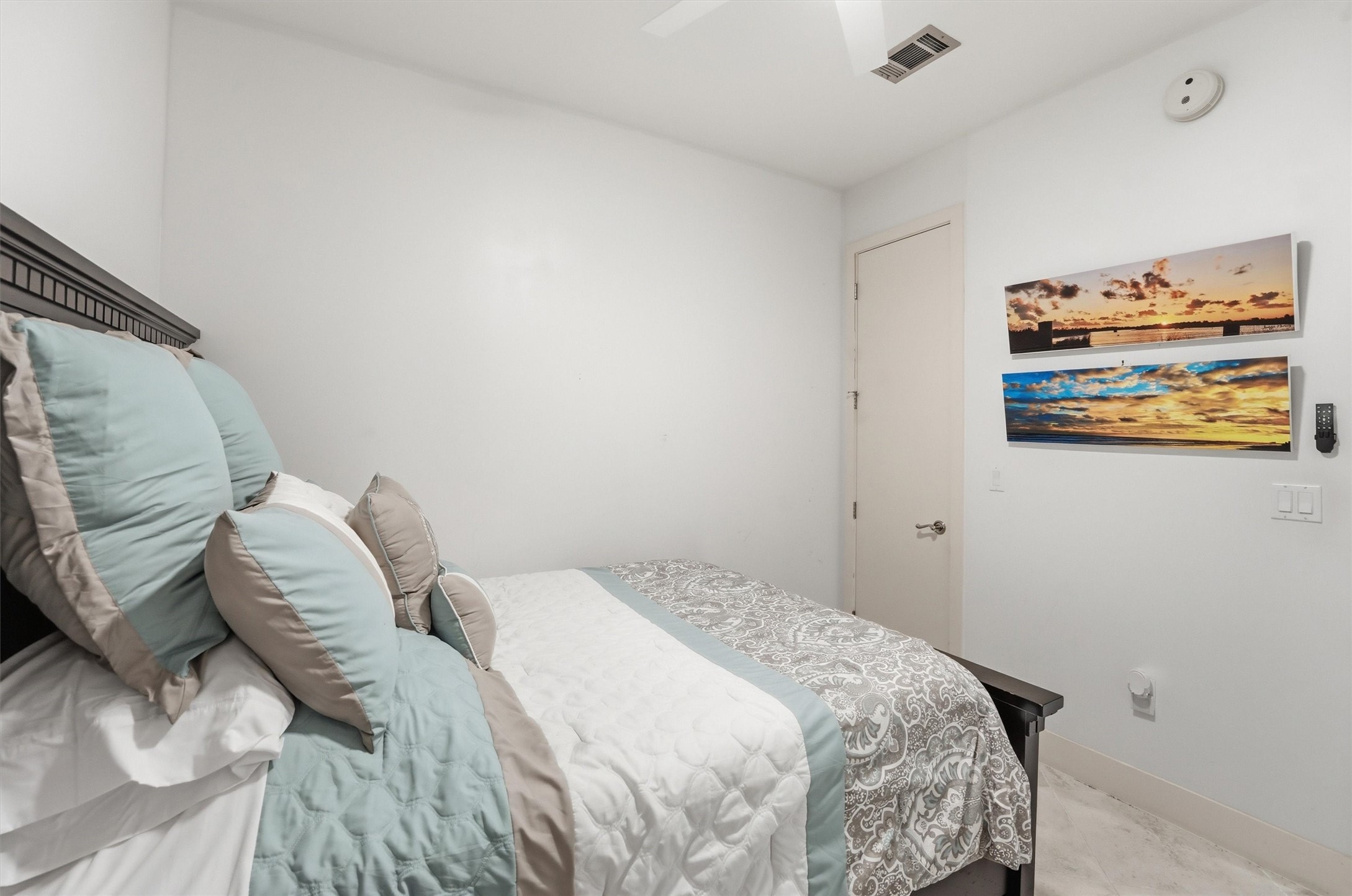 10327 Termini-San Luis Pass Road, Unit 616 Galveston, TX 77554 - Photo 20 of 38 a bedroom with a bed and a painting on the wall