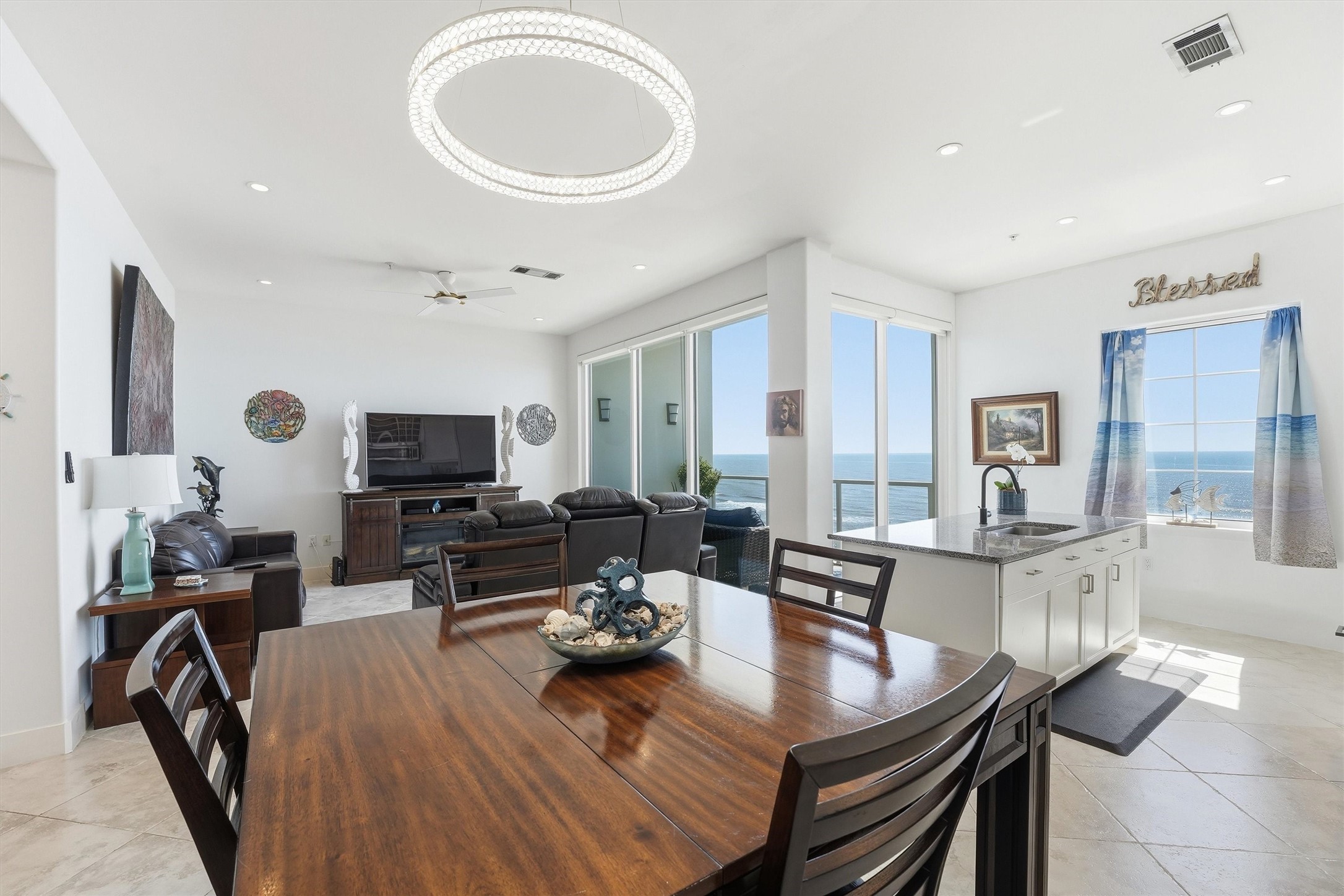 10327 Termini-San Luis Pass Road, Unit 616 Galveston, TX 77554 - Photo 3 of 38 a living room with furniture a flat screen tv and a large window