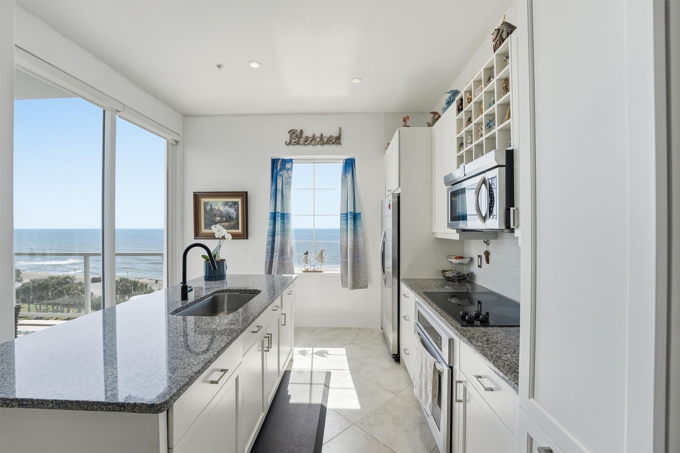 10327 Termini-San Luis Pass Road, Unit 616 Galveston, TX 77554 - Photo 8 of 38 a kitchen with granite countertop a sink and cabinets
