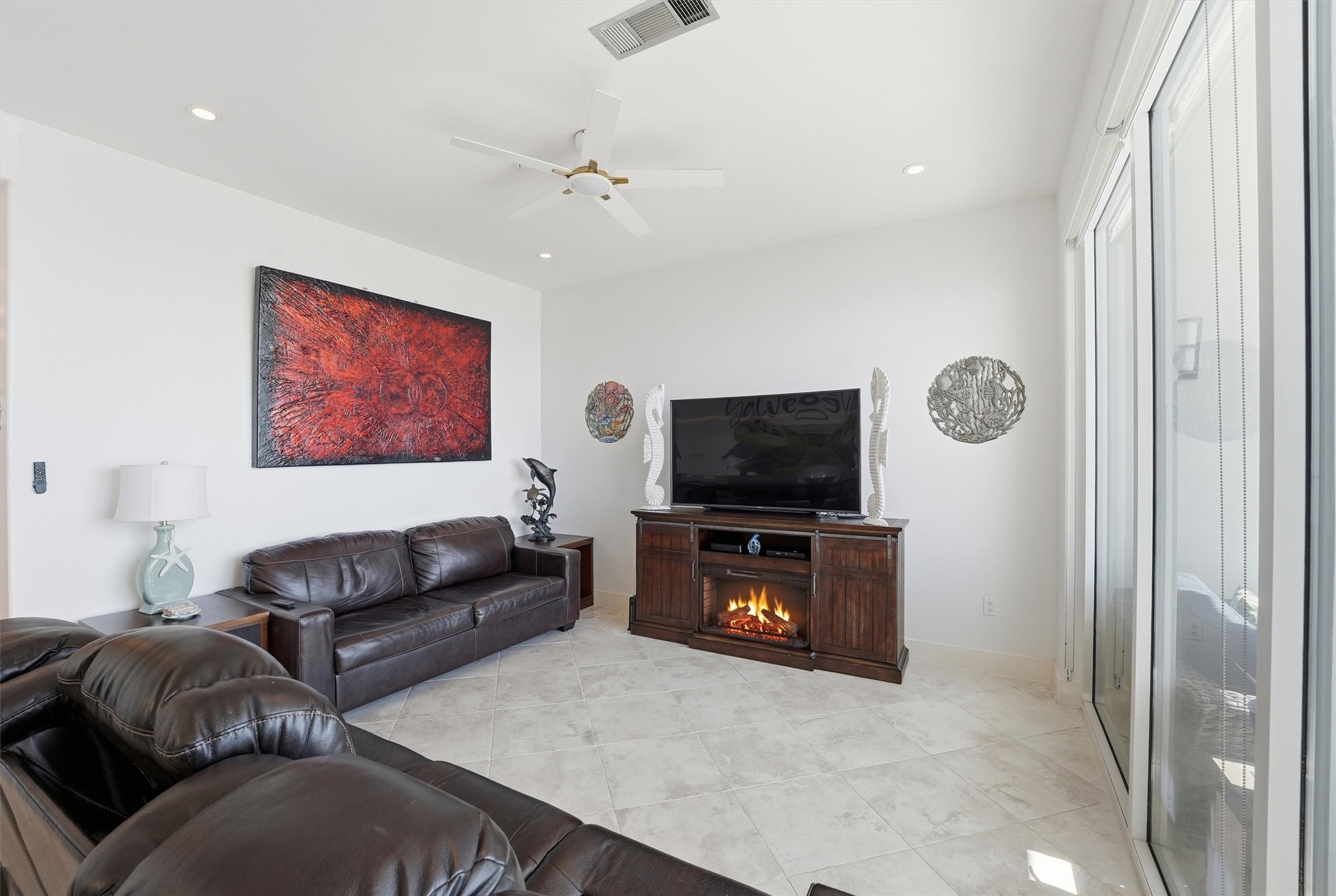 10327 Termini-San Luis Pass Road, Unit 616 Galveston, TX 77554 - Photo 10 of 38 a living room with furniture and a flat screen tv