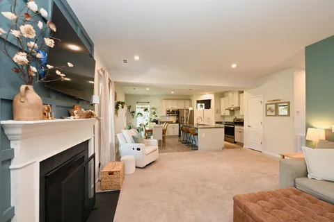 a living room with furniture and fireplace