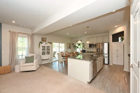 a view of a living room kitchen and a wooden floor