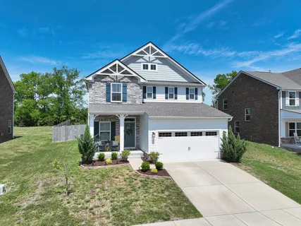 a front view of a house with garden