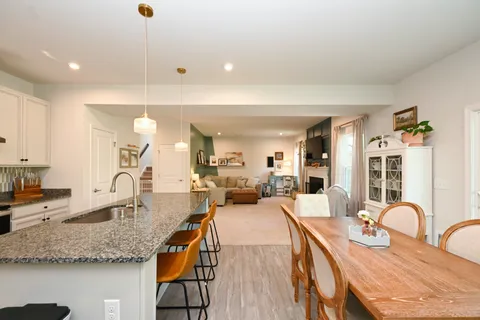 a large kitchen with granite countertop a large counter top appliances and cabinets