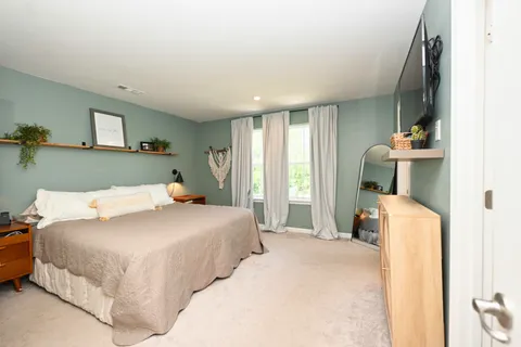 a bedroom with a bed and a couch