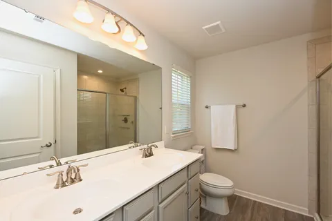 a bathroom with a sink toilet and mirror
