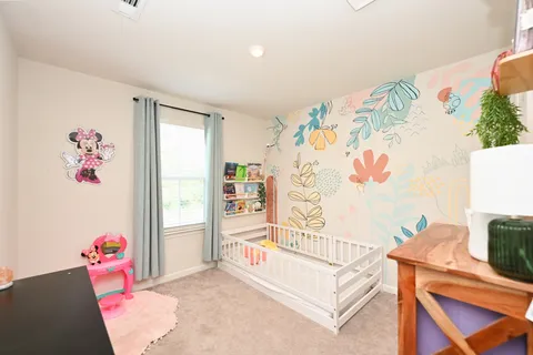 a bedroom with a bed and a couch