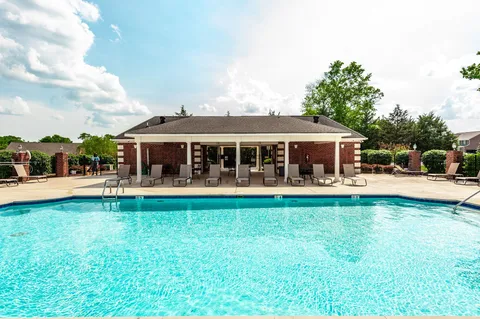 a front view of a house with swimming pool having outdoor seating