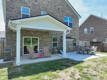 a view of a house with a patio and a garden