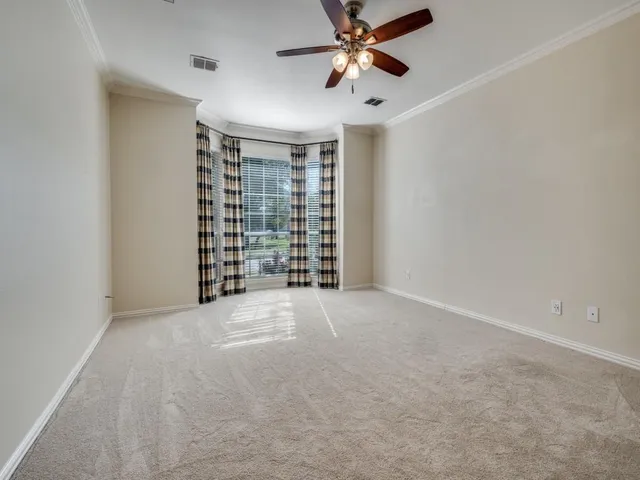 a spacious bathroom with a tub a double vanity sink a mirror and a shower