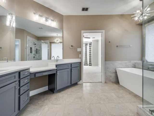 a spacious bathroom with a shower and a sink