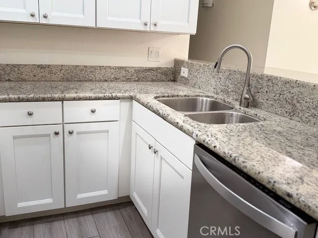 a close view of a sink and dishwasher in a kitchen