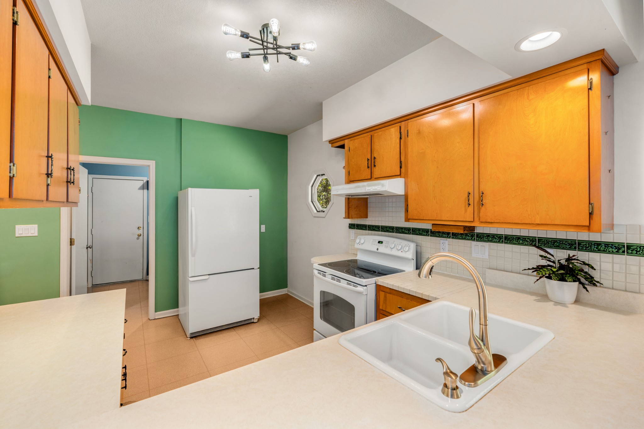 358 Harper Road Clarksville, TN 37043 - Photo 11 of 34 a kitchen with stainless steel appliances a sink a refrigerator a counter top space and a large window