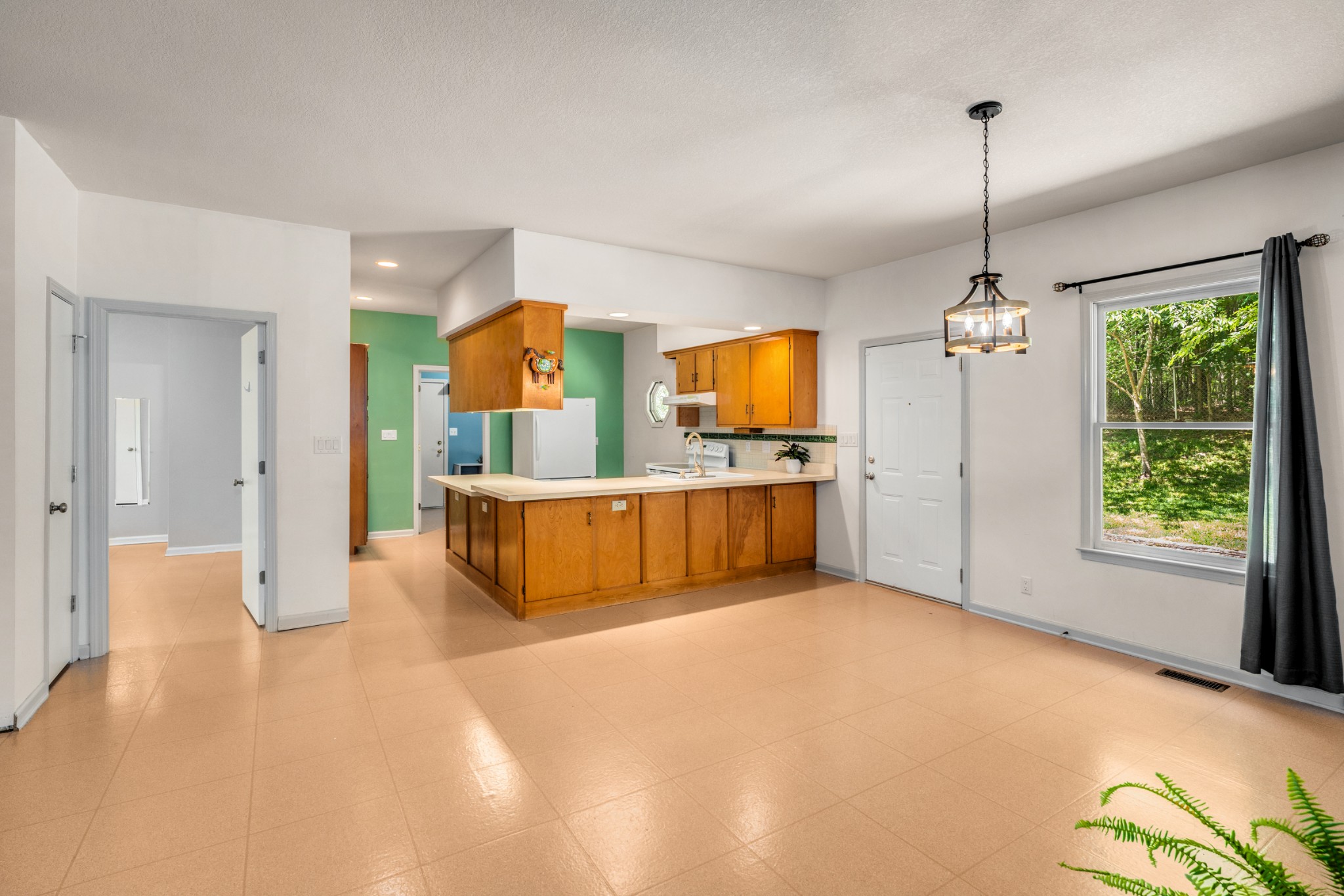 358 Harper Road Clarksville, TN 37043 - Photo 16 of 34 a view of a kitchen with a sink hardwood floor and a living room