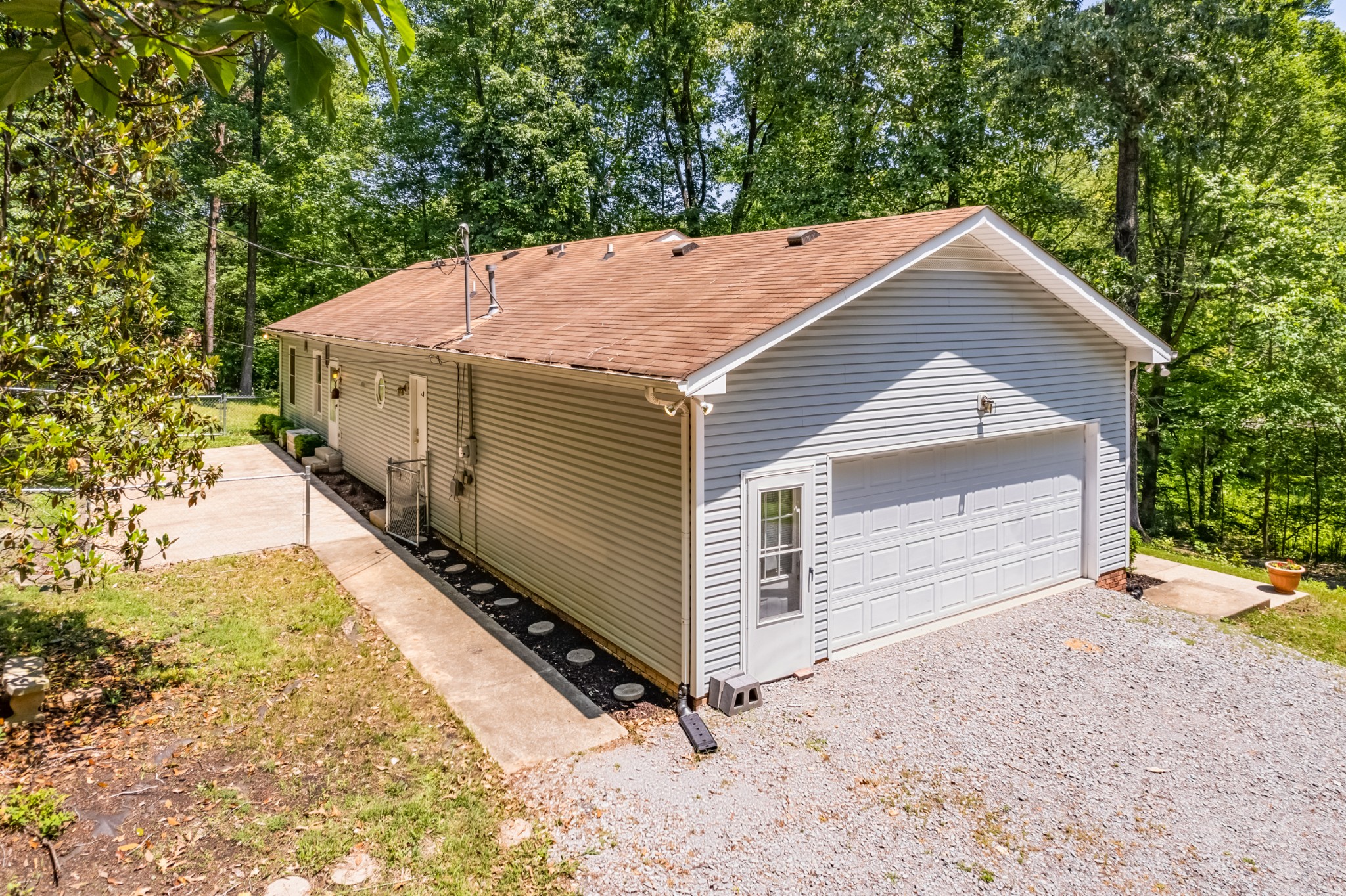 358 Harper Road Clarksville, TN 37043 - Photo 29 of 34 a view of a small house with a yard and large tree