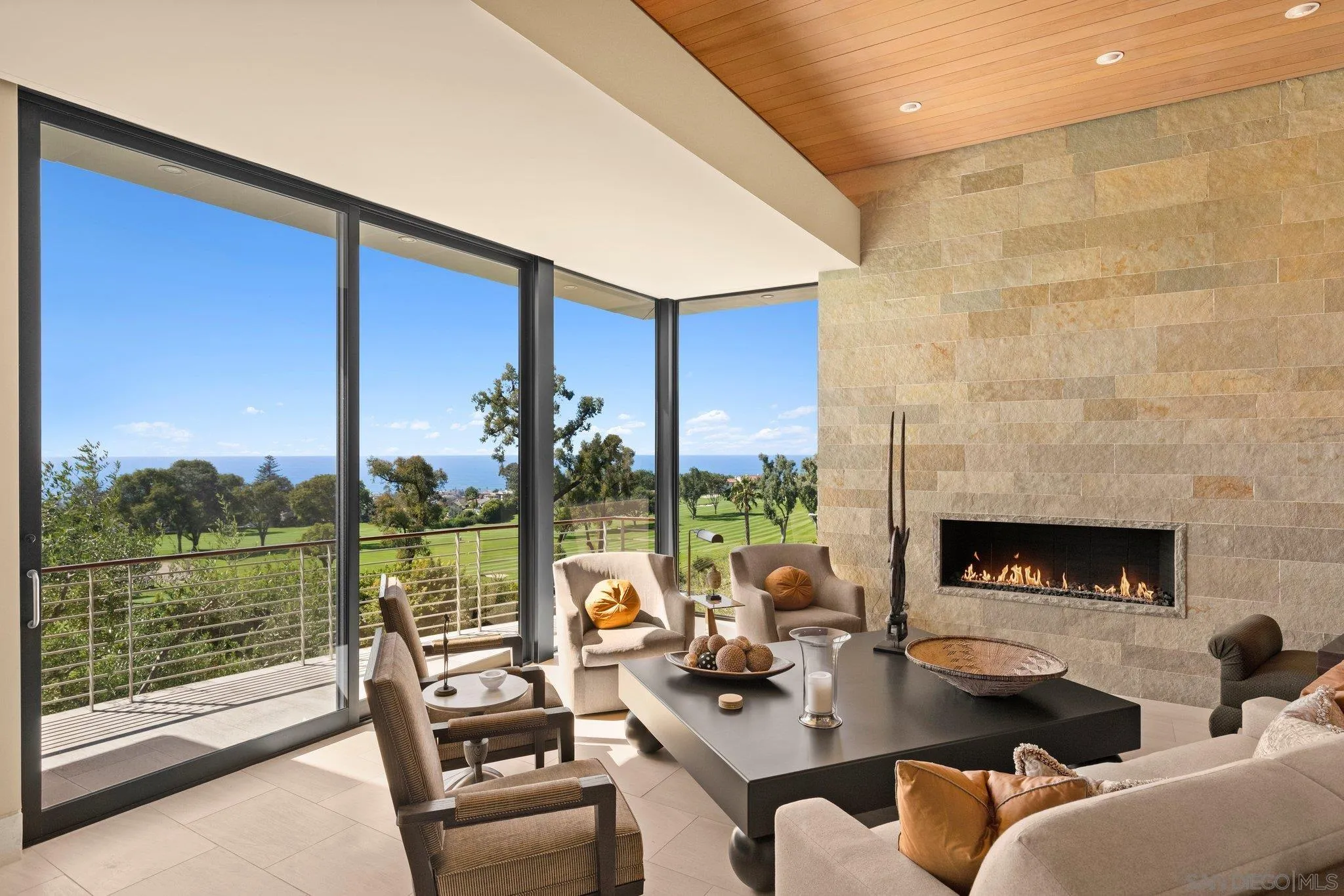 7413 Fairway Road La Jolla, CA 92037 - Photo 13 of 40 a living room with fireplace furniture and a floor to ceiling window