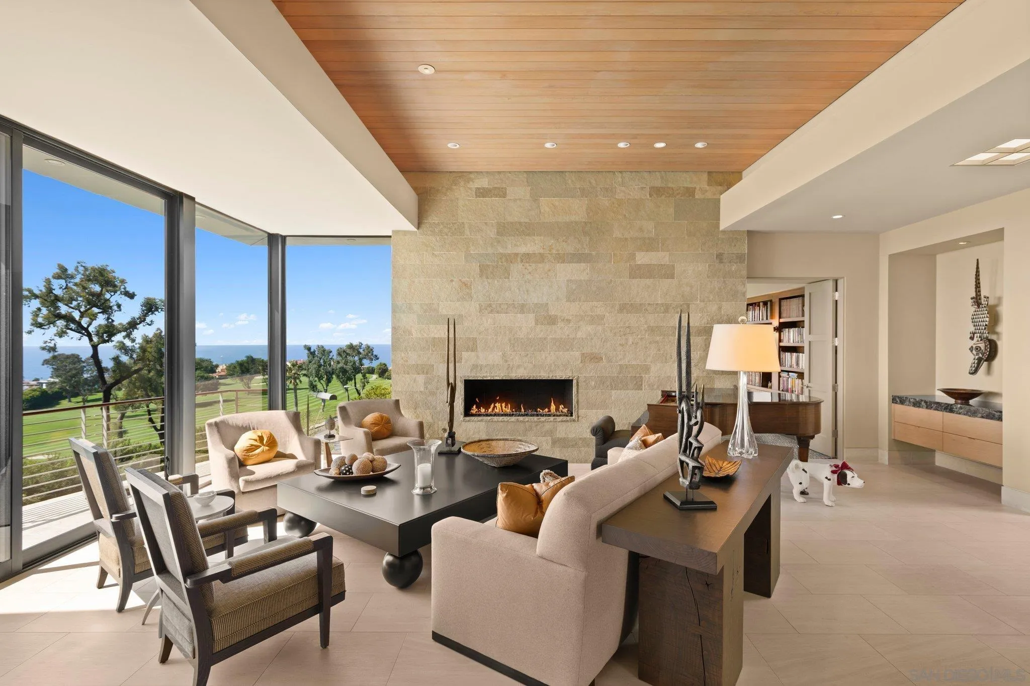 7413 Fairway Road La Jolla, CA 92037 - Photo 14 of 40 a living room with furniture a fireplace and a floor to ceiling window