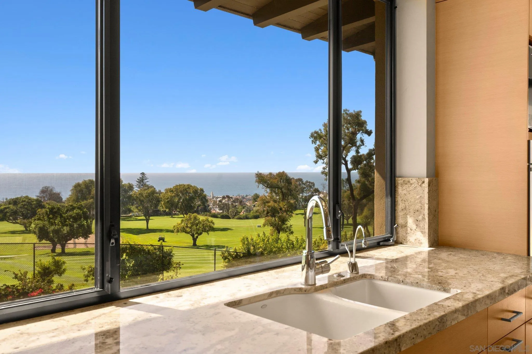 7413 Fairway Road La Jolla, CA 92037 - Photo 21 of 40 a bathroom with a granite countertop sink and a large window