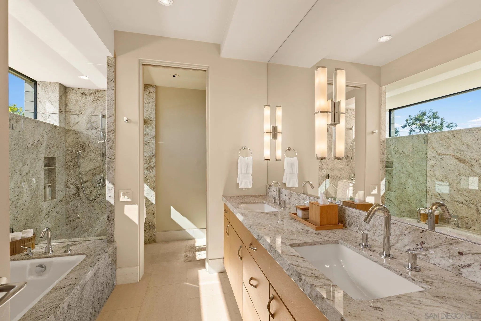 7413 Fairway Road La Jolla, CA 92037 - Photo 26 of 40 a bathroom with a granite countertop tub sink and mirror