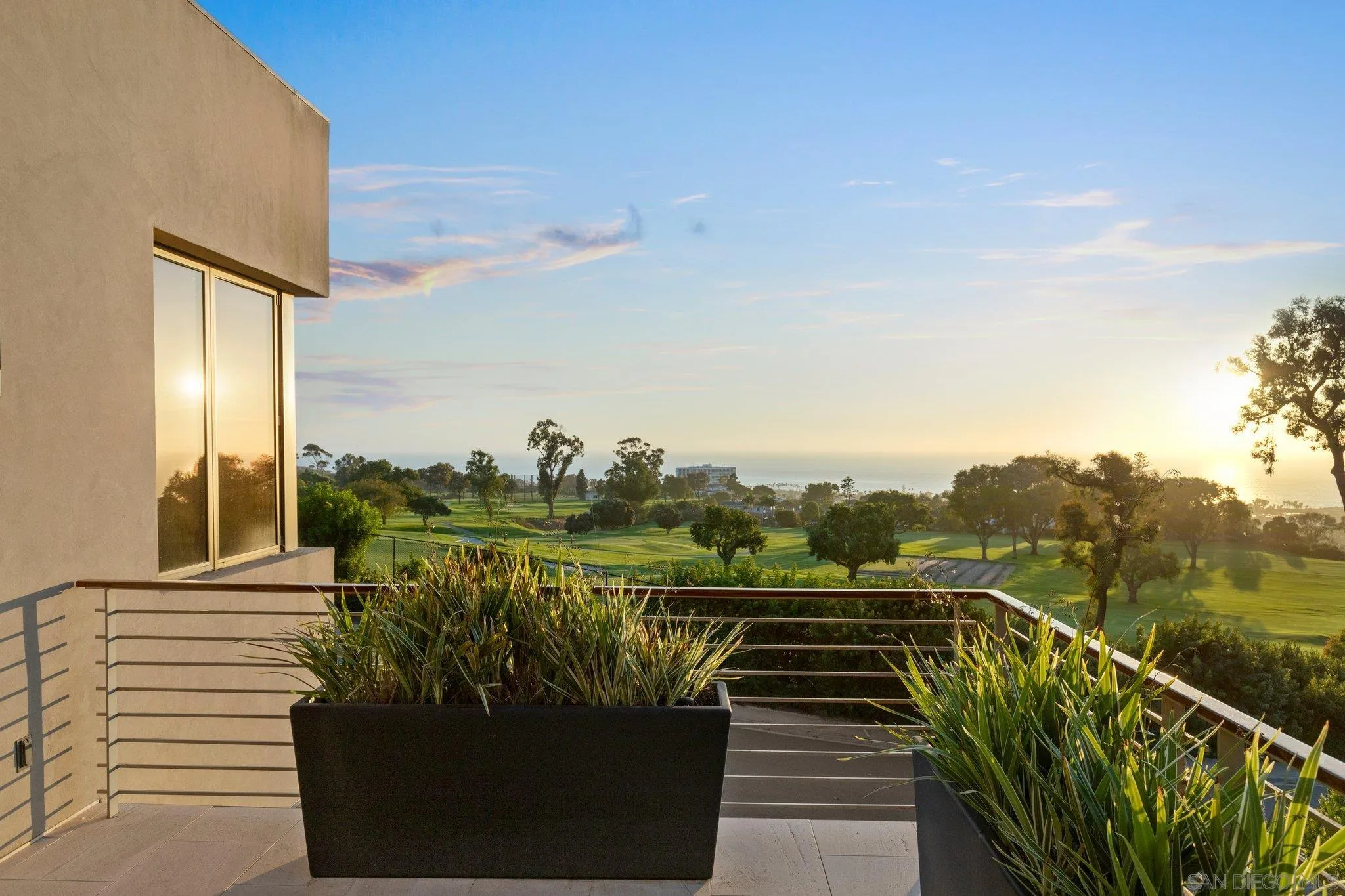7413 Fairway Road La Jolla, CA 92037 - Photo 3 of 40 a view of a balcony with lake view and wooden floor