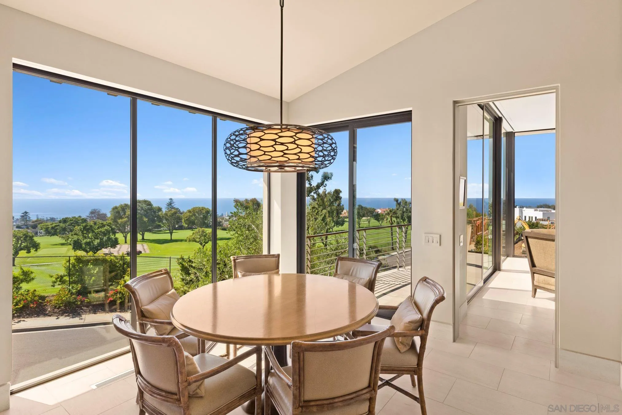 7413 Fairway Road La Jolla, CA 92037 - Photo 5 of 40 a dining room with furniture water view and a floor to ceiling window