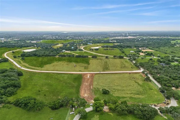 an aerial view of residential houses with outdoor space and swimming pool