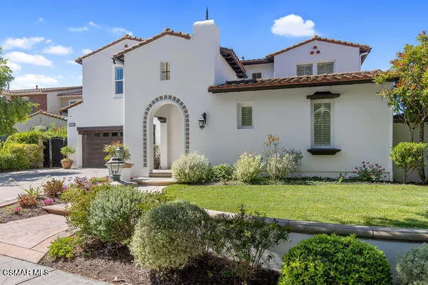 a view of a house with a yard and plants