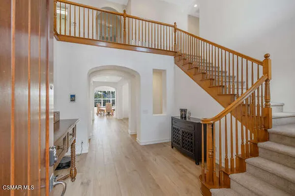 a view of entryway and hall with wooden floor