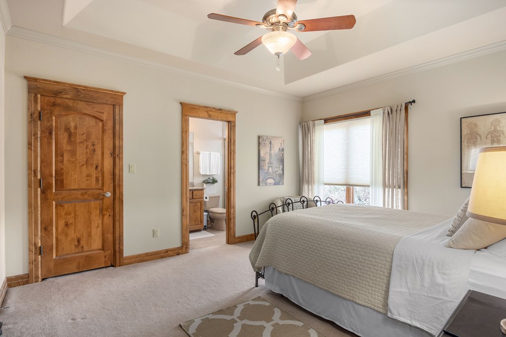 2121 Landmark Kerrville, TX 78028 - Photo 72 of 108 a bedroom with a bed and a chandelier