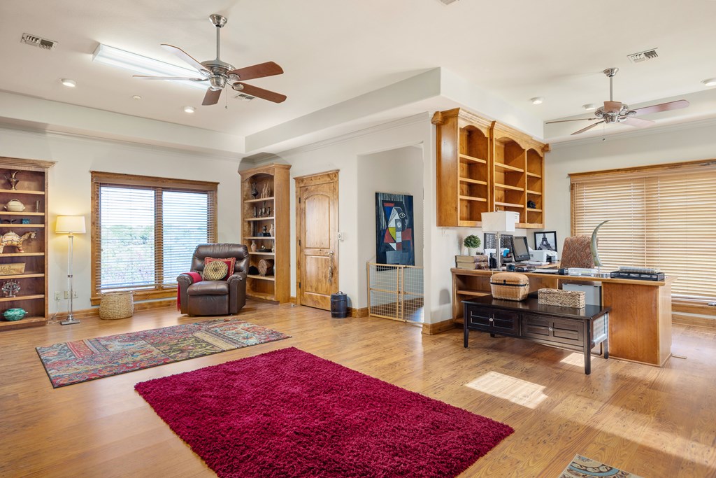 2121 Landmark Kerrville, TX 78028 - Photo 76 of 108 a living room with furniture a rug and a chandelier