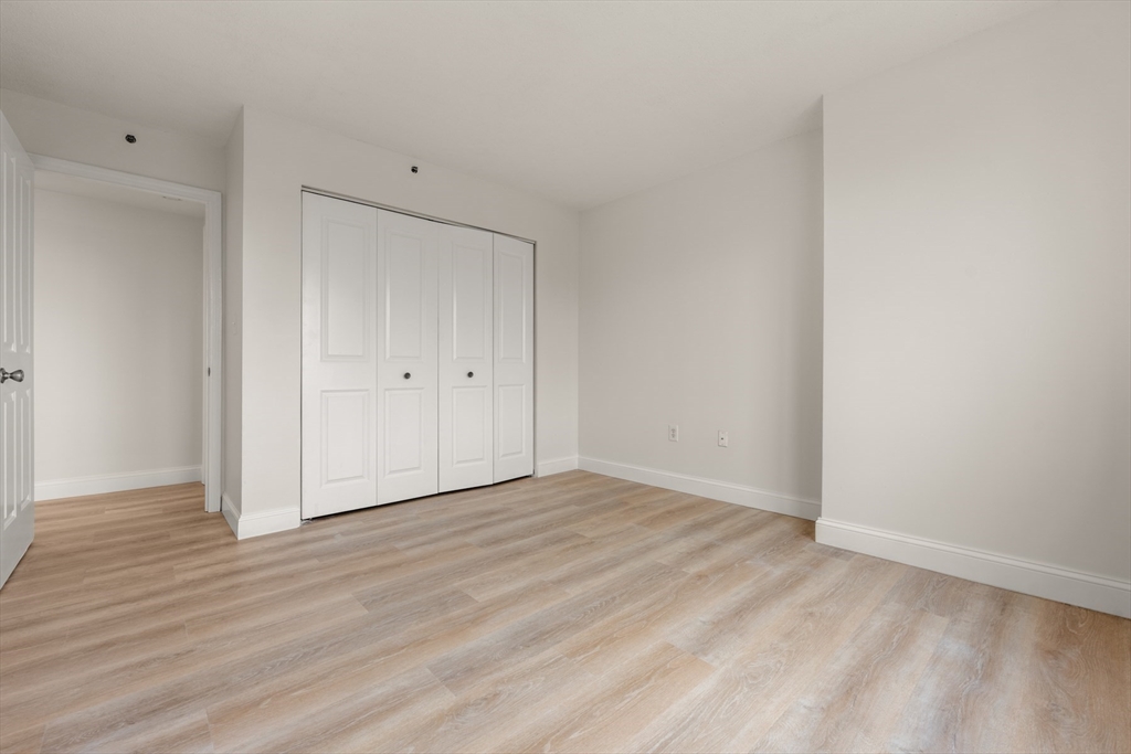 8 Museum Way, Unit 1006 Cambridge, MA 02141 - Photo 16 of 21 a view of an empty room with wooden floor