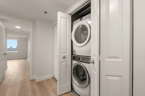 a view of a hallway with washer and dryer