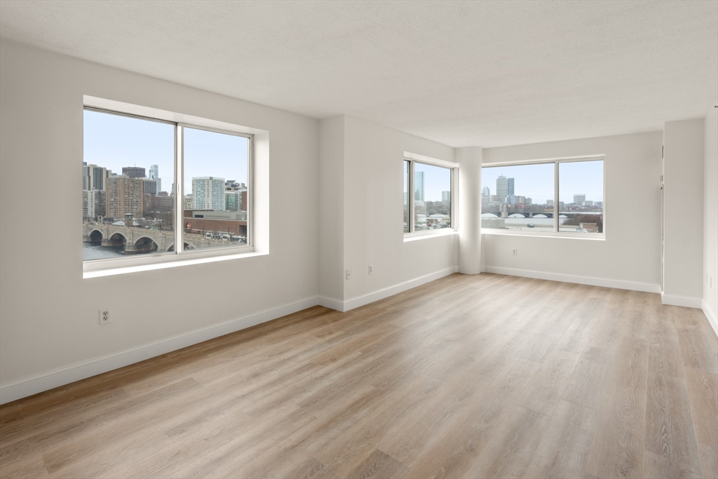 8 Museum Way, Unit 1006 Cambridge, MA 02141 - Photo 2 of 21 a view of empty room with wooden floor and fan