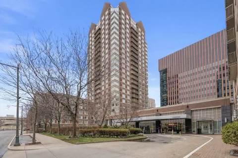 a view of a tall building next to a road