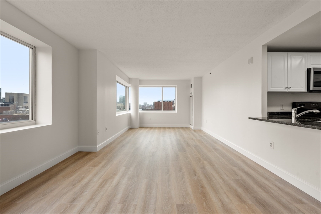 8 Museum Way, Unit 1006 Cambridge, MA 02141 - Photo 5 of 21 a view of a room with wooden floor and a window