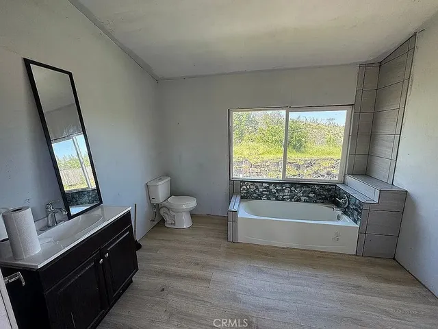 a bathroom with a bathtub sink and toilet