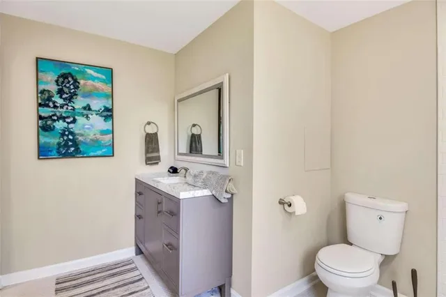 a bathroom with a toilet a sink and mirror