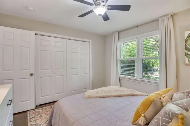 a bedroom with a large bed and a window