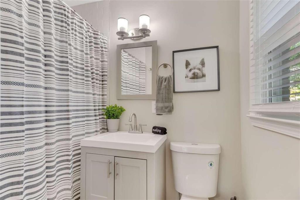 1386 Sandtown Road Southwest Marietta, GA 30008 - Photo 19 of 23 a bathroom with a sink a toilet and a window