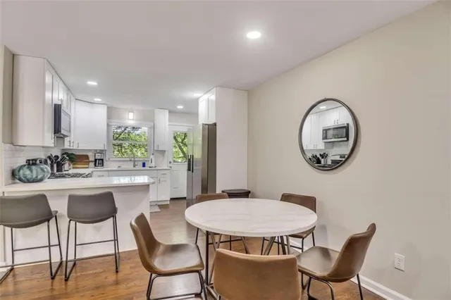 a view of a dining room with furniture and a mirror