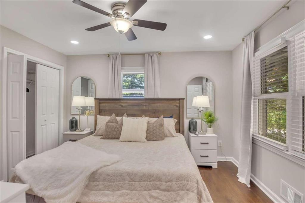 1386 Sandtown Road Southwest Marietta, GA 30008 - Photo 7 of 23 a bedroom with a bed chandelier and a window